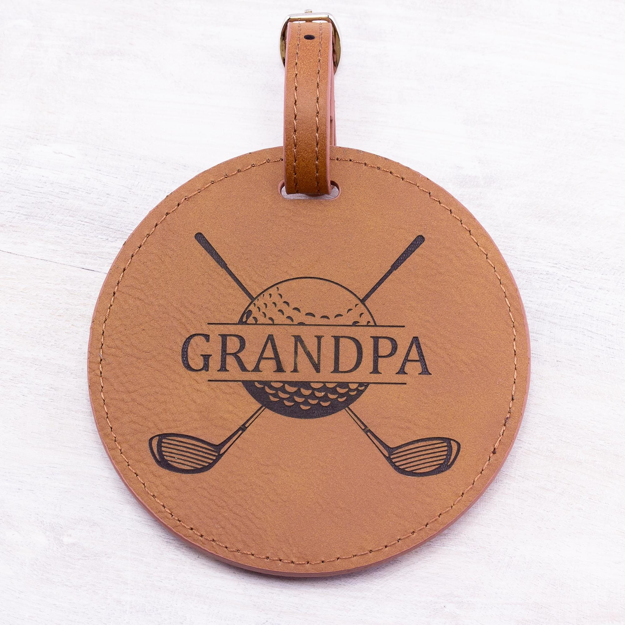 rawhide round leatherette golf bag tag with 5 golf tees on the back. Can be custom engraved with whatever you like.