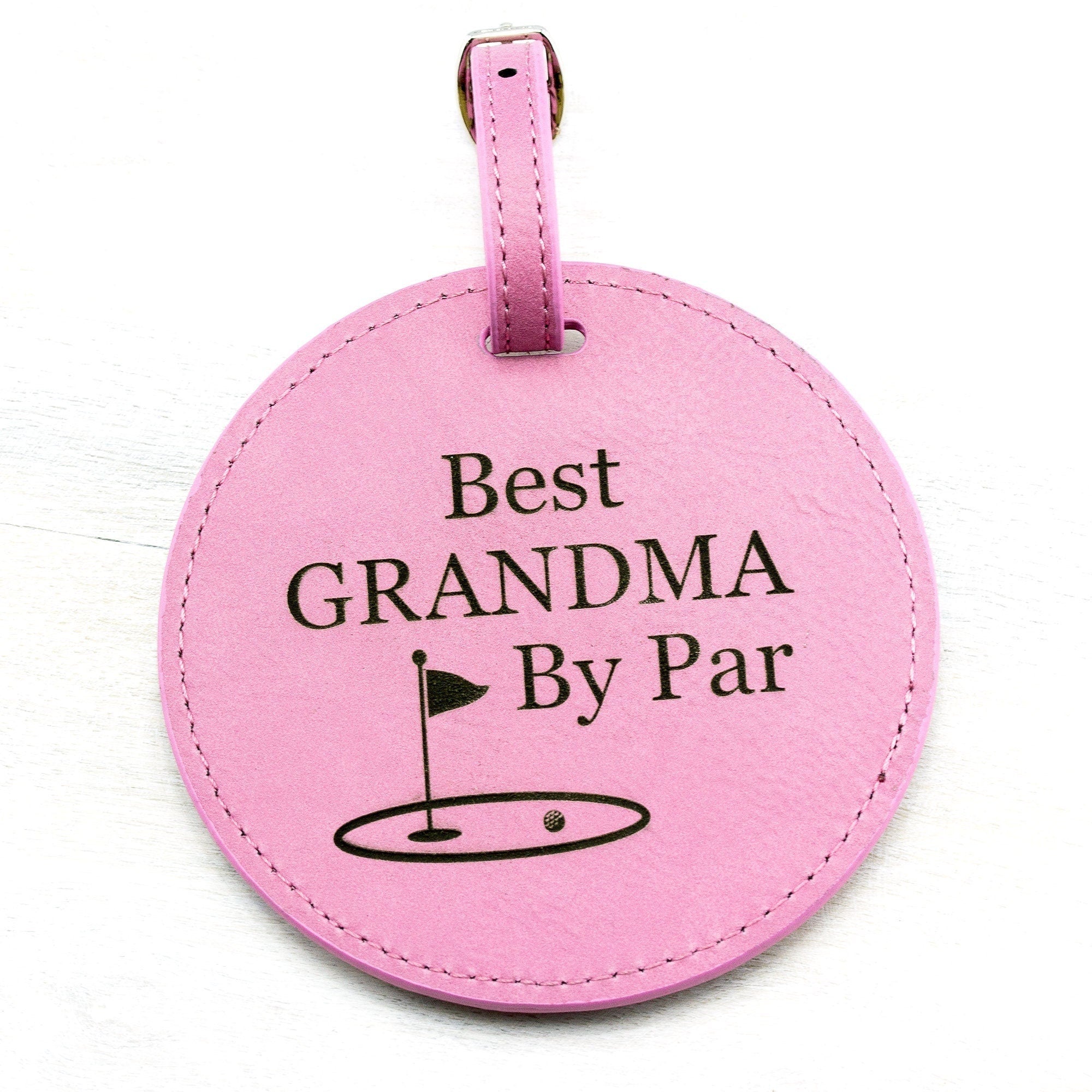 Leatherette golf bag tag tee holder with best grandma by par engraved in black. Holds 5 wooden golf tees.