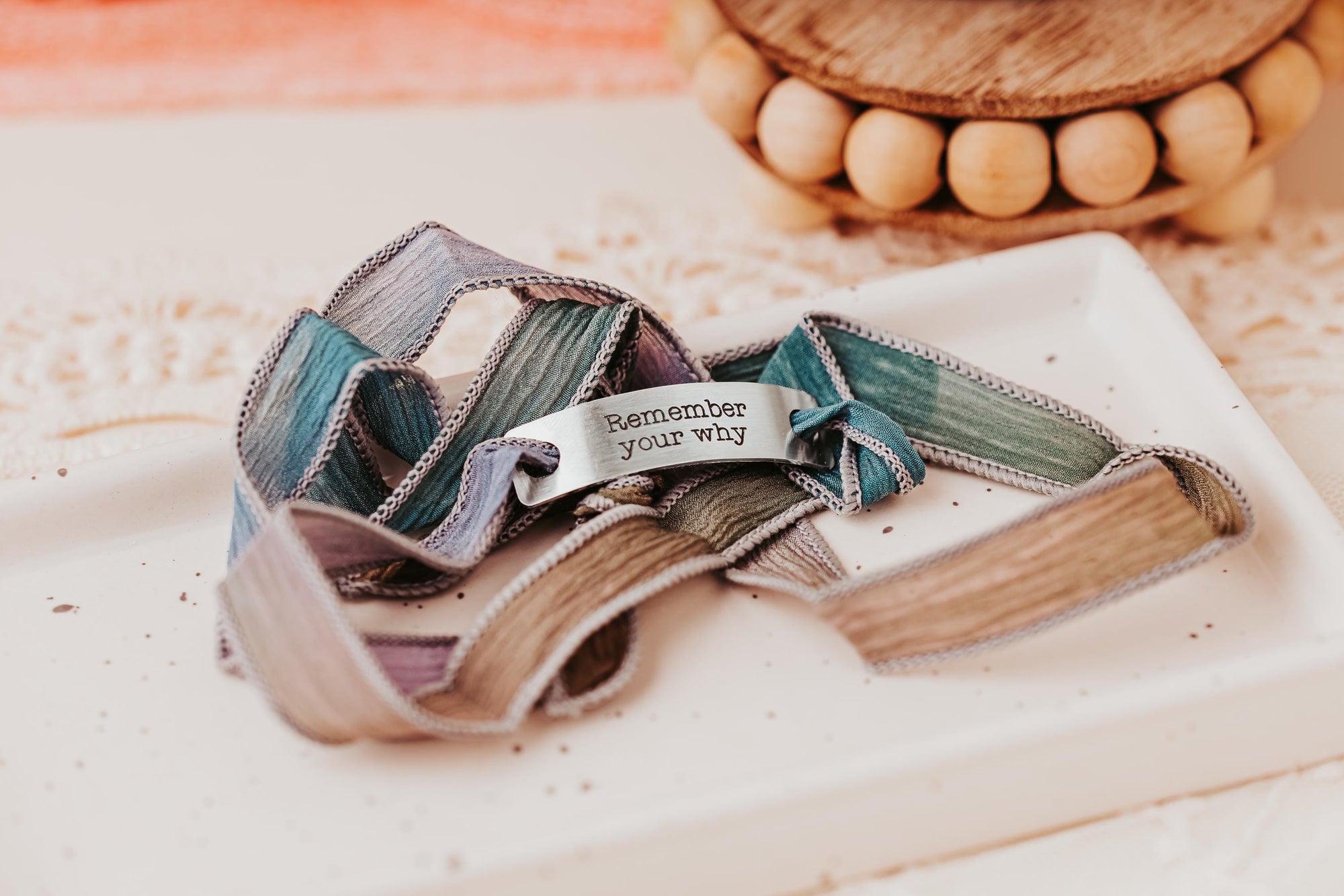 Silk wrap bracelet with stainless steel bar with what you want engraved.