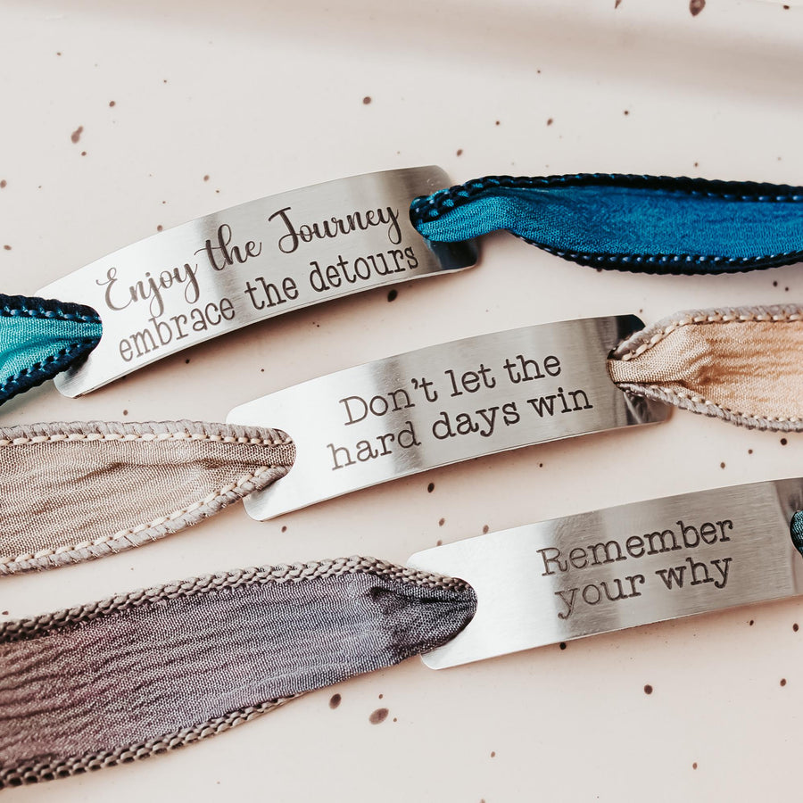 Silk wrap bracelet with stainless steel bar with what you want engraved.