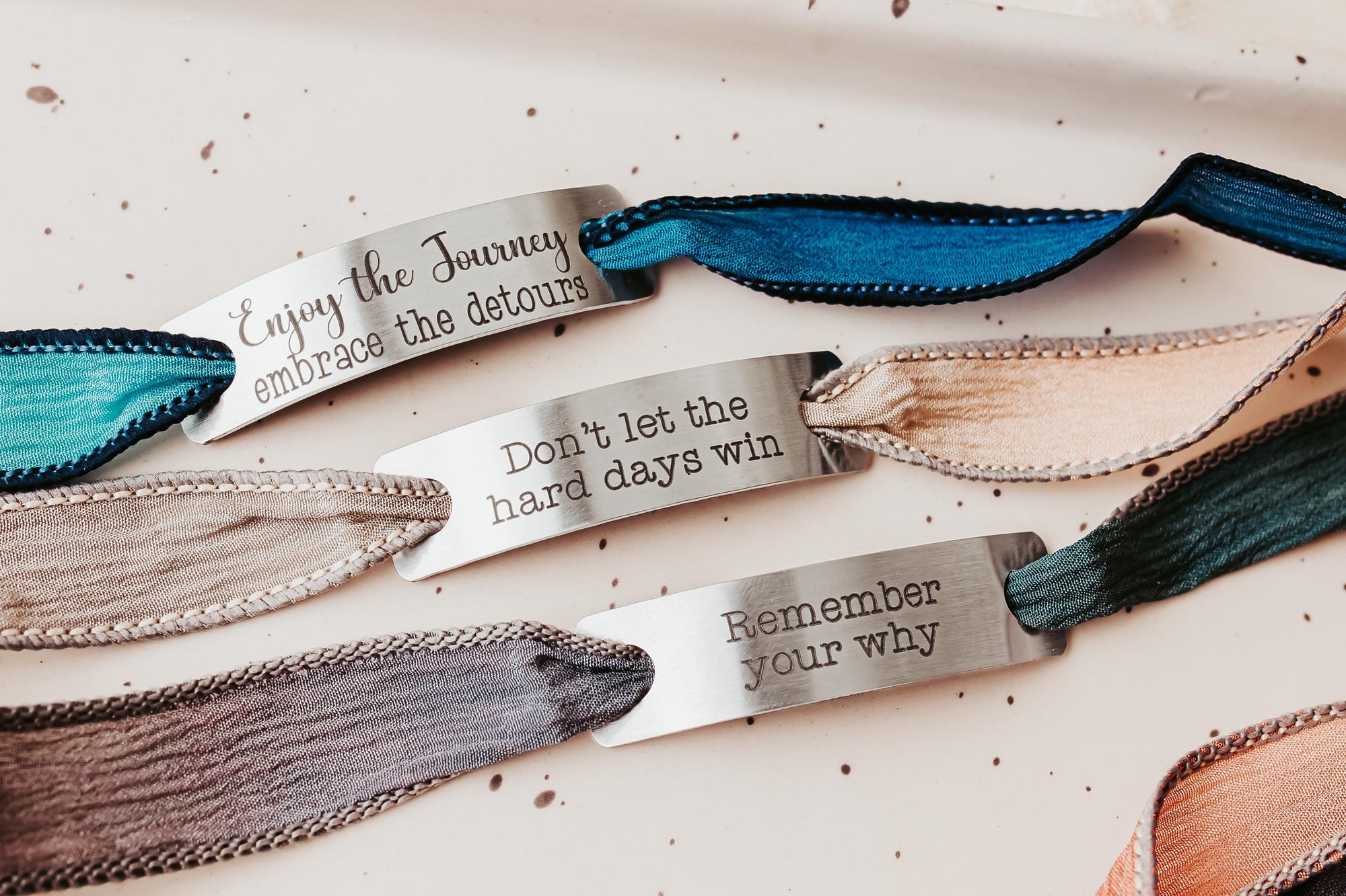 Silk wrap bracelet with stainless steel bar with what you want engraved.