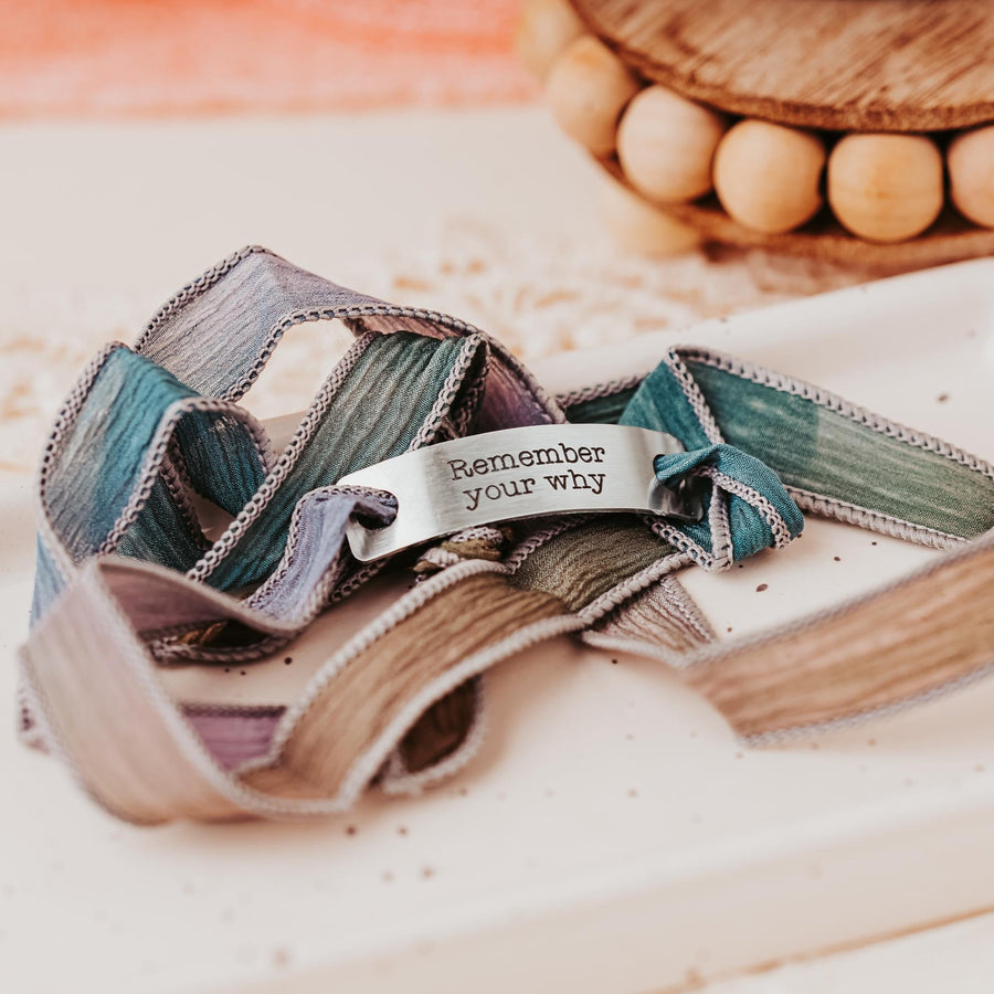 Silk wrap bracelet with stainless steel bar with what you want engraved.